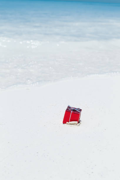 istock Packed gifts on sand with azur sea background 1281971696