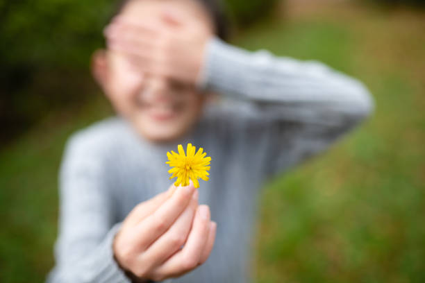 istock Shy girl presents flower 1281974007