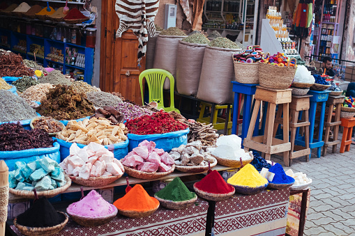 Colourful species in a shop. Market and People in Medina, Marrakech. These street markets are famous for a big offering of handmade products, dry fruits and spices.