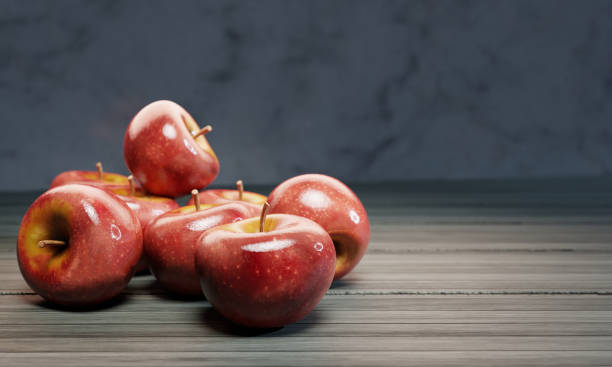 istock Fresh red apples are placed on a wooden table surface with a marble-patterned wall. 3D Rendering 1281975259