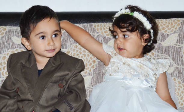 I love you honey A couple of cute boy and girl dressed up like a bride and a groom in a wedding ceremony and lovely looking at each other. bride hugging father on wedding day stock pictures, royalty-free photos & images