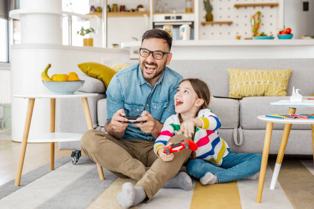 istock Gaming time for father and daughter 1281984391