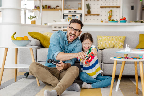istock Gaming time for father and daughter 1281984415