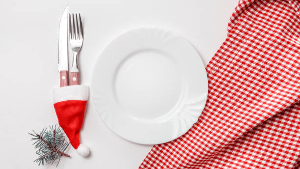istock Traditional Christmas table place setting with empty white plate, linen napkin, cutlery with festive decorations. New Years background and Holiday concept. Flat lay, top view with copy space 1281985549