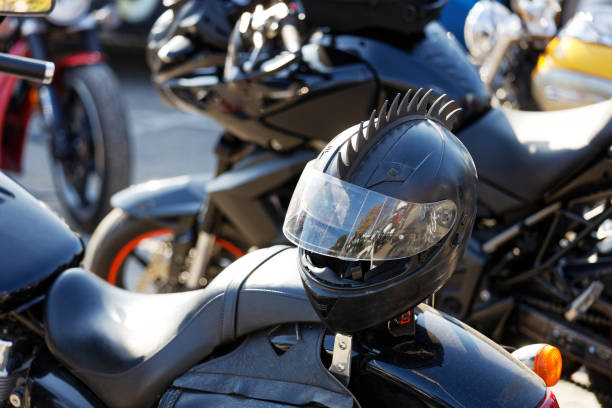 istock Closeup black moto helmet on motorcycle handlebars and motorbikes on blurred background 1281985571