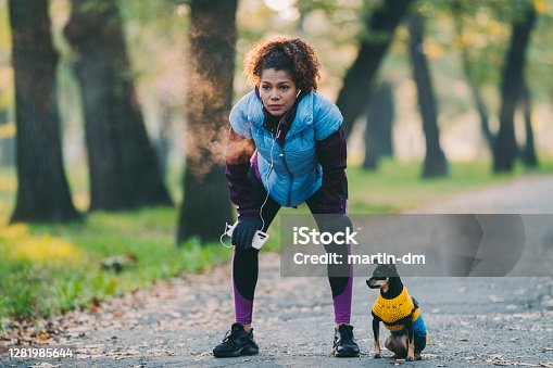 istock Sportswoman taking a breath after jogging 1281985644