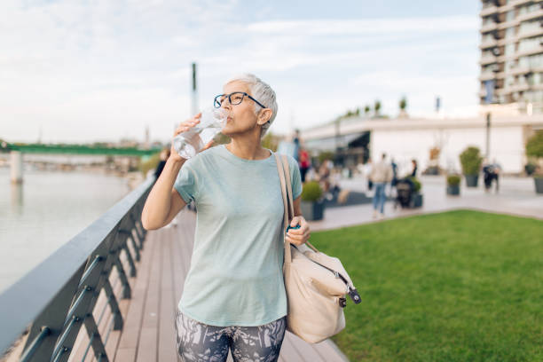 istock Senior woman refreshing after training outdoors 1281987903