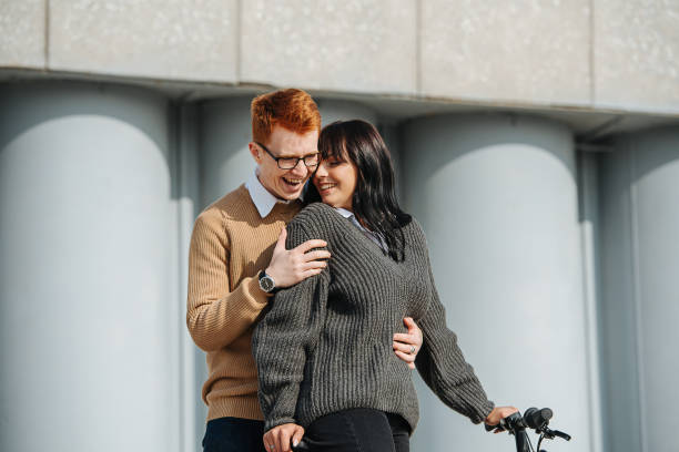 istock Perfect couple, young man hugging girlfriend on ebike, she snuggles back 1281988442