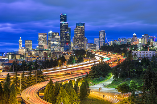 Seattle, Washington, USA downtown skyline and highways at dusk.