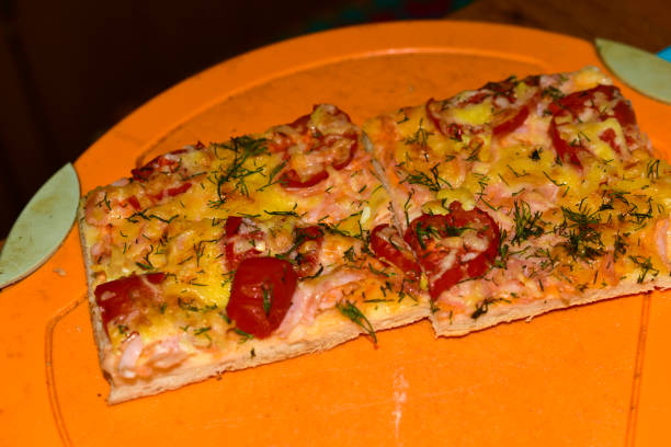 istock Homemade pizza cut into a square with ham and cheese 1281992105