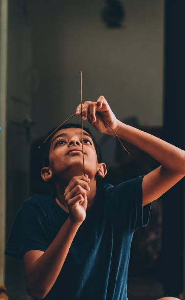 istock boy playing with bow and arrow made with stick 1281998280
