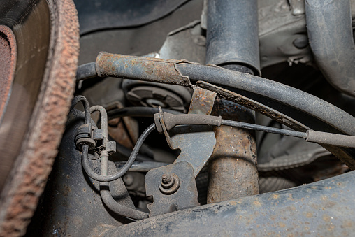 Old brake hose system, mounted to the car, visible parts of the brake system and tube fittings.