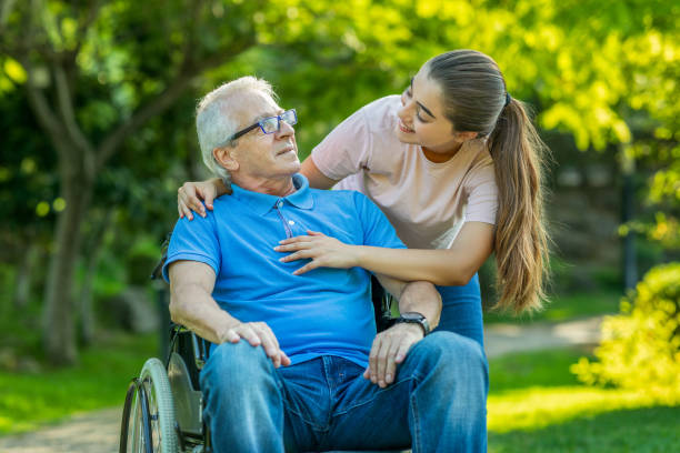 istock Senior man sitting on a wheelchair with granddaughter 1282001969