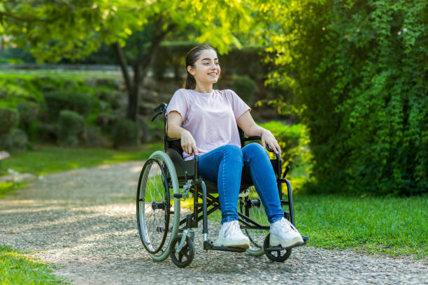 istock Disabled young woman in a park 1282003222