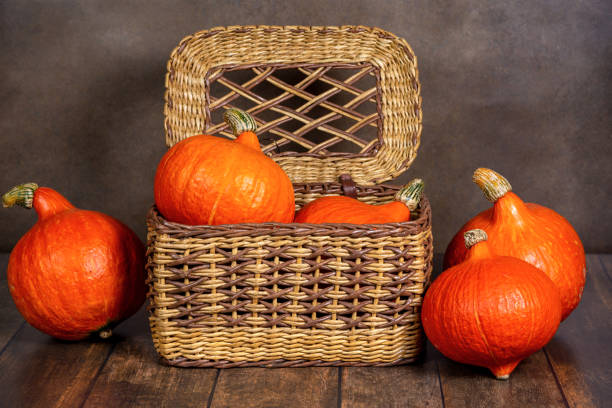 istock Basket on the table with pumpkins and autumn leaves 1282003306