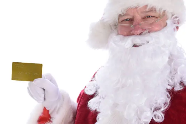 Closeup of Santa Claus holding his personal Noth Pole Gold Credit Card, isolated on white.