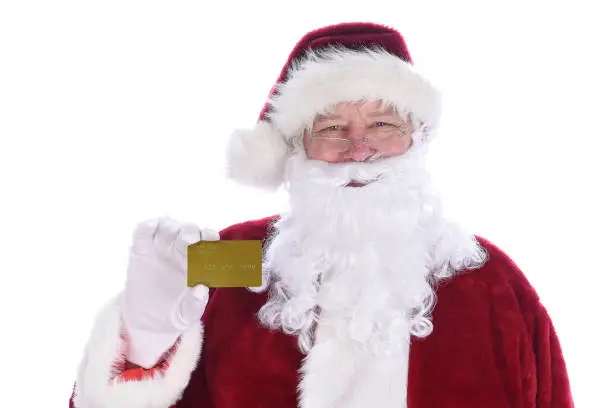 Santa Claus holding his personal Noth Pole Gold Credit Card, isolated on white.