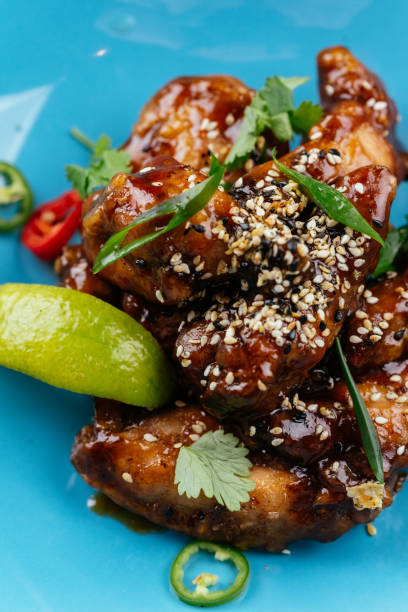 istock chicken wings in Chinese hot sauce with a slice of lime 1282005895