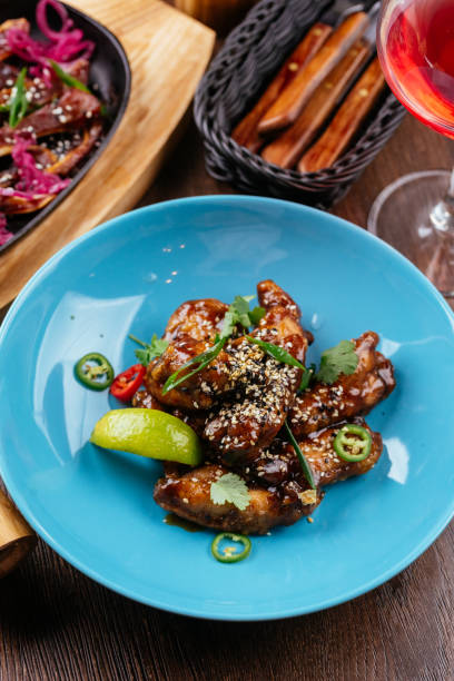 istock chicken wings in Chinese hot sauce with a slice of lime 1282005899