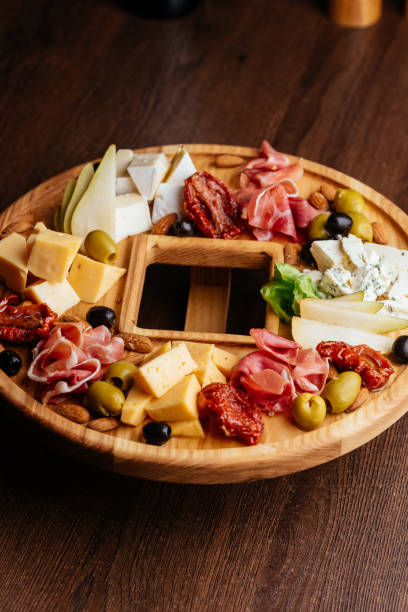 istock large wooden plate with cheese slices 1282005952