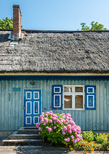 Traditional fisherman's house in Nida, Lithuania. Nida is a resort town in Lithuania. Located on the Curonian Spit between the Curonian Lagoon and the Baltic Sea.