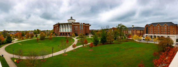 Panorama of an autumn, colorful lawn surrounded by buildings in downtown Lexington, Kentucky Main library building with the lawn in front of it. Trees are covered with colorful leaves during early fall. university of kentucky campus stock pictures, royalty-free photos & images