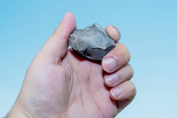 istock ale hand holds a piece of stone with sharp chips. 1282008997