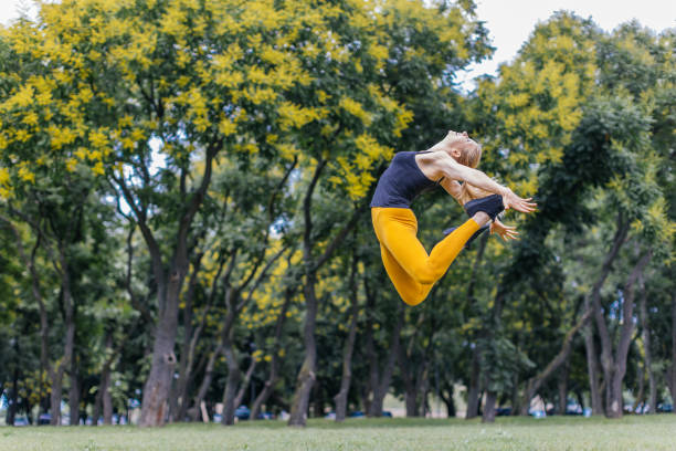 istock young woman jumping high in the park 1282010314