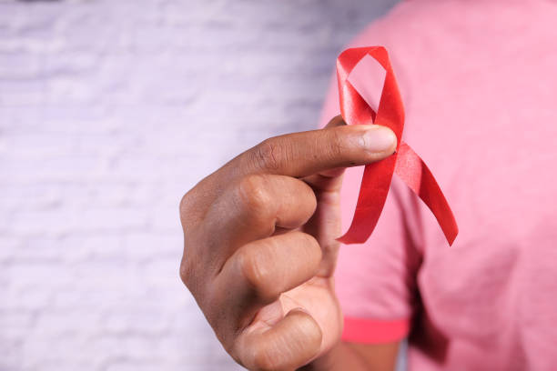 istock hand holding red HIV ribbon with copy space 1282013760