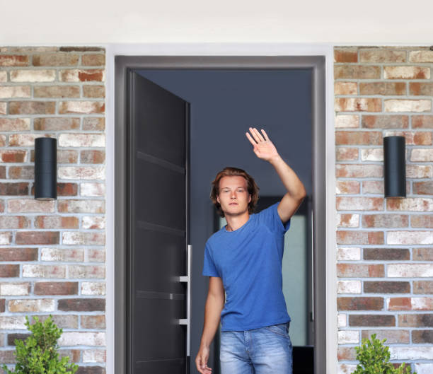 istock man opening the door .Inviting the guests 1282017622