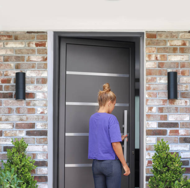 istock woman opening the door .Inviting the guests 1282017645