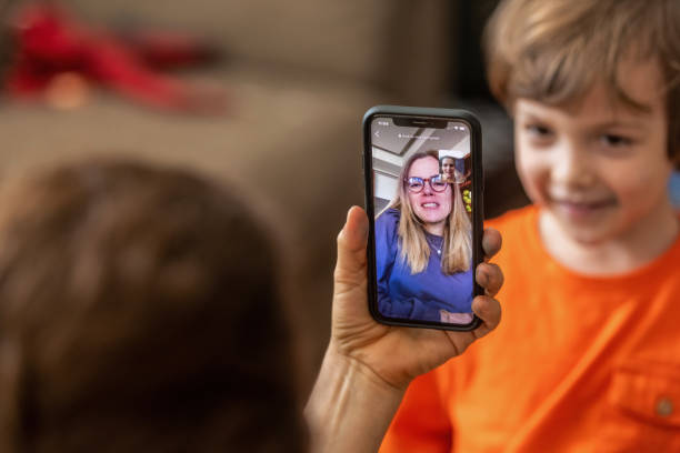 istock Mother and son teleconferencing with aunt using a smart phone 1282019646