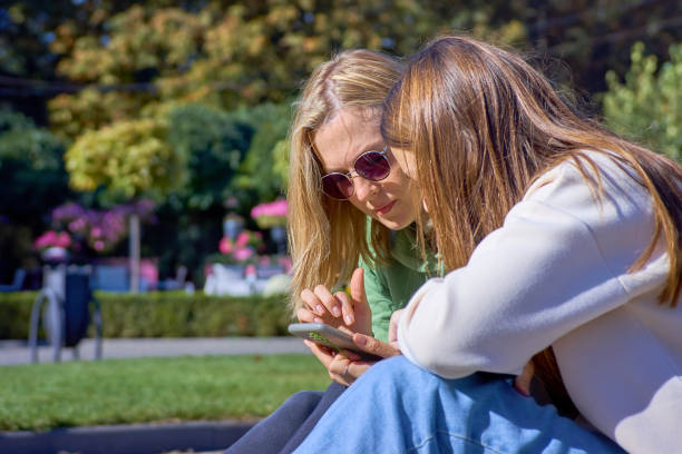 istock Young women using smartphone outdoors 1282019724