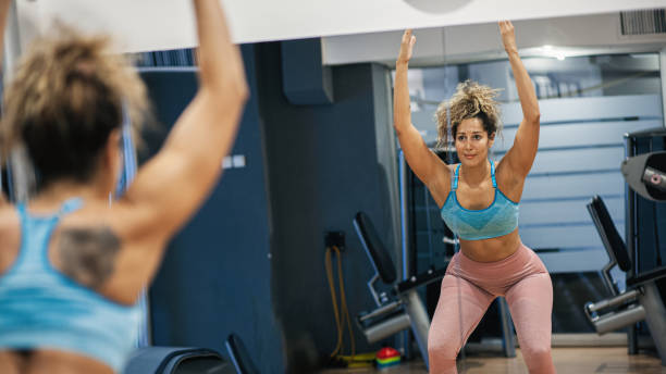 istock Beautiful woman exercising with balance training platform ball 1282022981