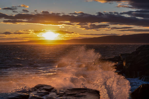 istock Sun Setting over the Ocean on the Rocky Coast of Maine 1282024905
