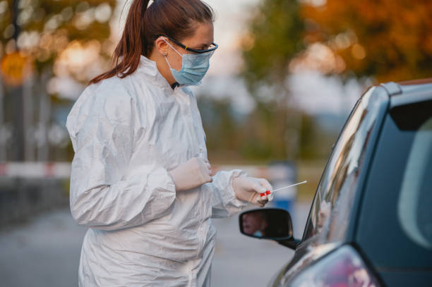 istock Female Frontline Worker at Drive Thru Medical Test Site 1282026192