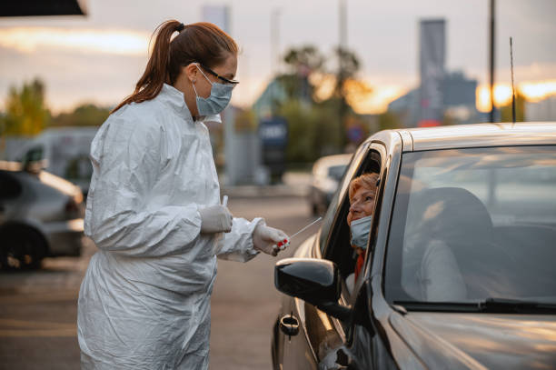 istock Frontline Worker with Swab at Drive Thru Medical Test Site 1282026204