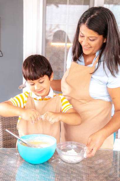istock little boy and his mother making cake together 1282030841