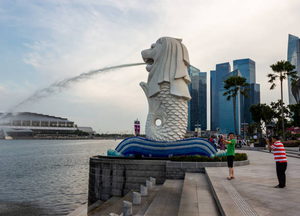 Singapore City, Singapore - October 4th, 2011: Merlion park is in the central business district of Singapore. It is a popular tourist attraction over looking the Marina Bay towrds the Sand Htel and the ArtScience Museum.