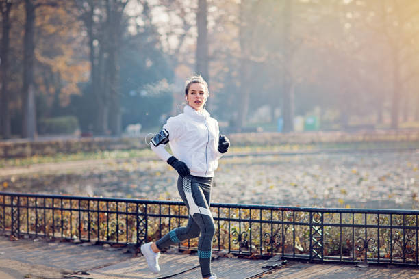 istock Young woman is running in a cold autumn morning 1282036100