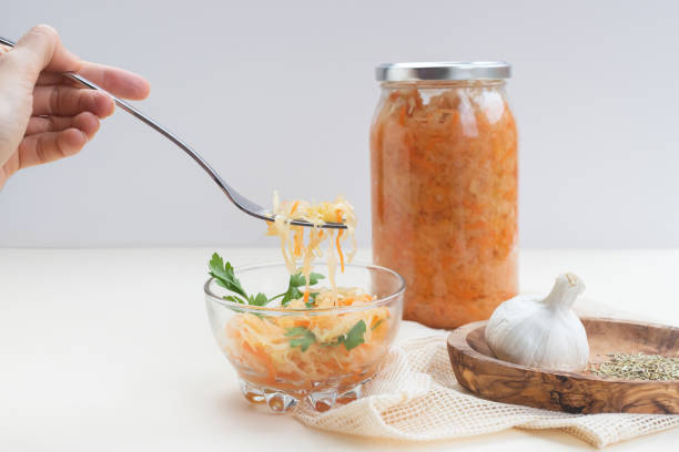 istock eating fermented food, sauerkraut or fermented cabbage with carrots on a light background 1282037143