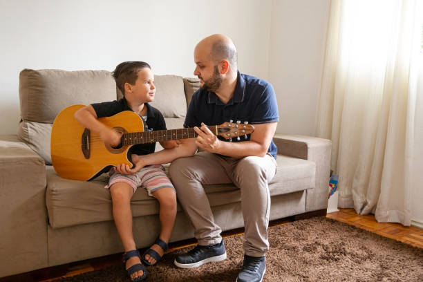 istock Father and son playing music at home. 1282039156
