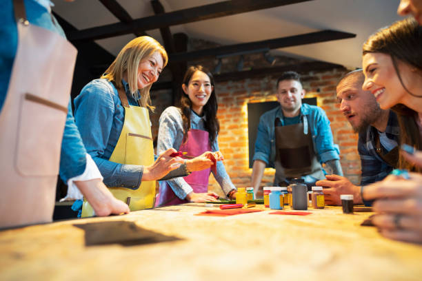 istock Smiling group of people at the workshop class learning from a female teacher 1282041078