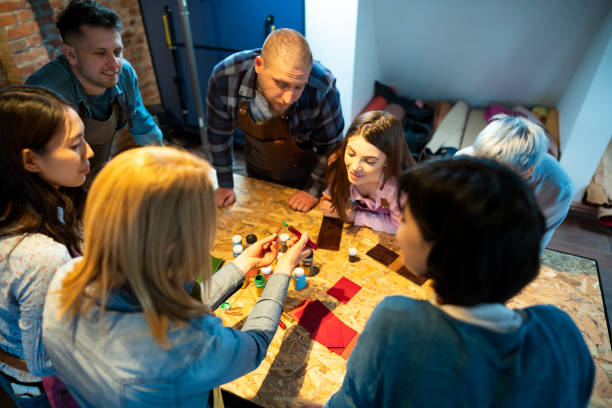 istock High angle view of a group of people at the workshop class learning about coloring leather 1282041080