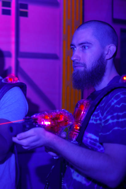istock entertainment war game laser tag gun playing in dark with black lignt 1282048467