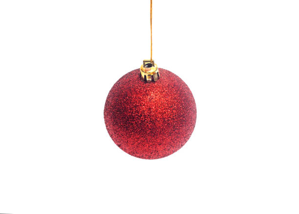 istock Red Christmas ball hanging on ribbon isolated on white background 1282050979