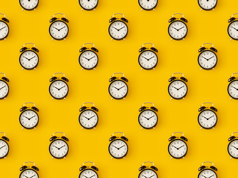 Seamless repetitive clock pattern on yellow background