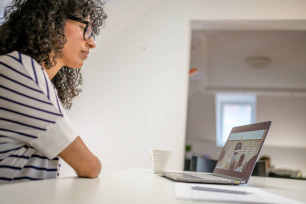 istock Woman watching webinar on laptop computer at home. 1282054185