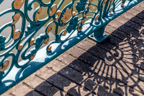 istock Wrought iron decorative fence on bridge and shadow. 1282055149