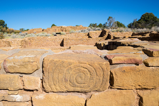 Spiral petroglyph carved into the side of a stone of the Pipe Shrine House in Mesa Verde National Park (Colorado).